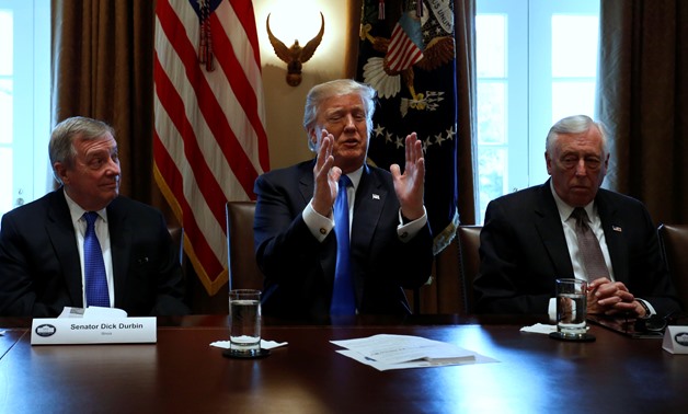 U.S. President Donald Trump, flanked by U.S. Senator Dick Durbin (D-IL) and Representative Steny Hoyer (D-MD), holds a bipartisan meeting with legislators on immigration reform at the White House in Washington, U.S. January 9, 2018. REUTERS/Jonathan Ernst