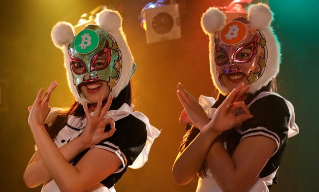 Members of Japan's idol group "Virtual Currency Girls" wearing cryptocurrency-themed masks pose after performing in their debut stage event in Tokyo, Japan, January 12, 2018. REUTERS/Kim Kyung-Hoon