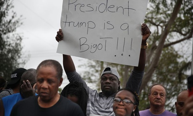 Demonstrators condemn President Donald Trump's reported statement about immigrants from Haiti, Africa and El Salvador on January 12, 2018 in Miami, Florida