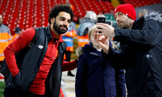 Soccer Football - FA Cup Third Round - Liverpool vs Everton - Anfield, Liverpool, Britain - January 5, 2018 Liverpool's Mohamed Salah poses for a photograph with a fan in the stadium before the match  -  REUTERS/Phil Noble