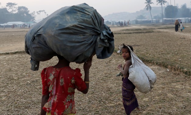 Rohingya refugee children walk inside Balukhali camp, near Cox's Bazar, Bangladesh January 12, 2018. REUTERS/Tyrone Siu