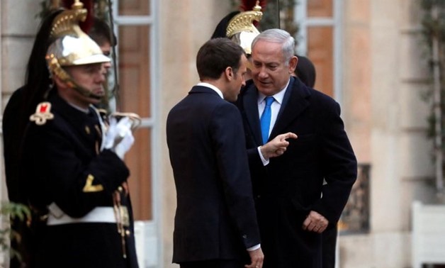 File photo: French President Emmanuel Macron speaks with Israeli Prime Minister Benjamin Netanyahu following a meeting at the Elysee Palace in Paris, France December 10, 2017. REUTERS/Philippe Wojazer