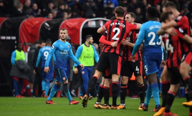 Soccer Football - Premier League - AFC Bournemouth vs Arsenal - Vitality Stadium, Bournemouth, Britain - January 14, 2018 Arsenal's Jack Wilshere looks dejected after the match as Bournemouth celebrate REUTERS/Dylan Martinez