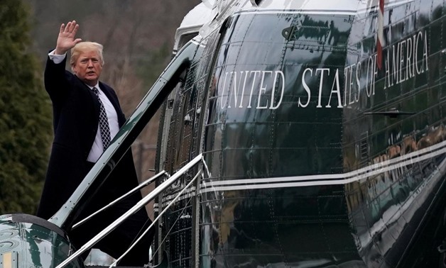 U.S. President Donald Trump waves from the steps of Marine One helicopter upon his departure after his annual physical exam at Walter Reed National Military Medical Center in Bethesda, Maryland, U.S., January 12, 2018. REUTERS/Yuri Gripas