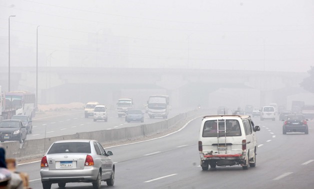 File – Cars driving on the foggy ring road in Cairo