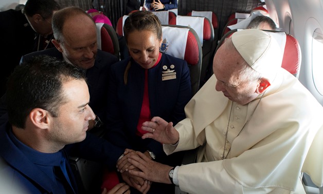 Pope Francis celebrates the marriage of crew members Paula Podest (C) and Carlos Ciufffardi (L) during the flight between Santiago and the northern city of Iquique, Chile January 18, 2018. Osservatore Romano/Handout via REUTERS