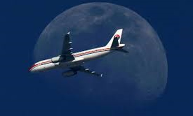 FILE PHOTO - A China Eastern Airlines passenger jet passes in front of the moon over Shanghai May 13, 2011. REUTERS/Aly Song/File Photo