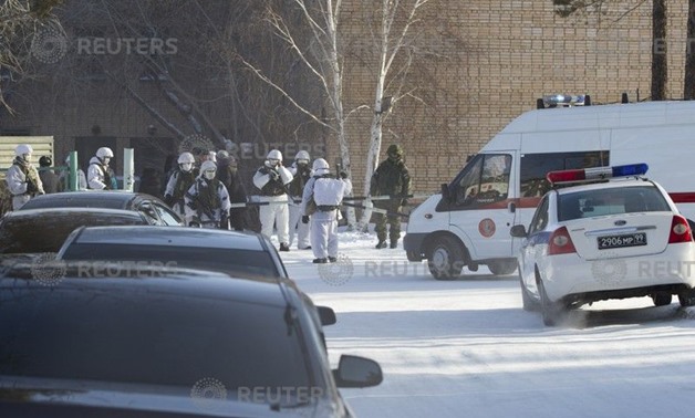 Law enforcement officers stand guard near a local school after a student with an axe attacked schoolchildren and a teacher in Ulan-Ude - REUTERS