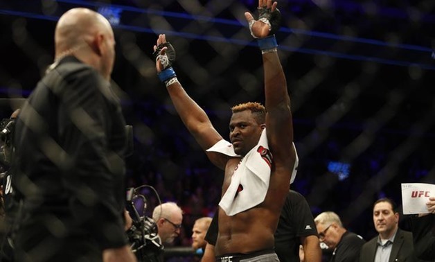 Dec 2, 2017; Detroit, MI, USA; Francis Ngannou (blue gloves) reacts to fight against Alistair Overeem (red gloves) during UFC 218 at Little Caesars Arena. Mandatory Credit: Raj Mehta-USA TODAY Sports