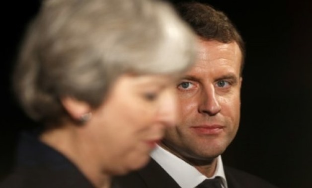 AFP | French President Emmanuel Macron (R), seen here next to British Prime Minister Theresa May, said he regretted the Brexit vote and "would love to welcome" the UK back