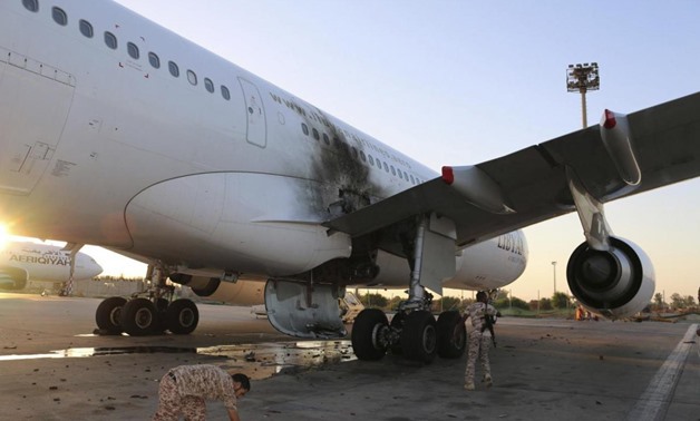A damaged aircraft is pictured after a shelling at Tripoli International Airport July 15, 2014. REUTERS/Hani Amara
