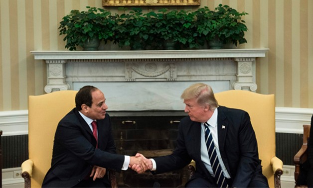 Egypt's President Abdel Fattah al-Sisi and US President Donald Trump shake hands in the Oval Office before a meeting at the White House - AFP/Brendan Smialow