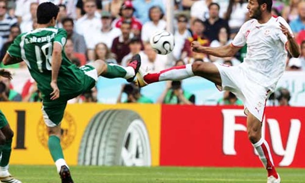 Saudi Arabia's Nawaf Al-Temyat battles for the ball with Tunisia's Yassine Chikhaoui during Group H World Cup 2006 soccer match - Santabanta.com

