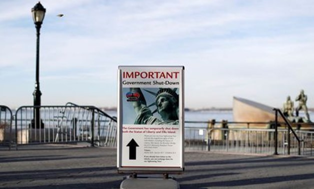 A sign announcing the closure of the Statue of Liberty sits near the ferry dock to the Statue of Liberty at Battery Park, New York, Jan. 20, 2018. REUTERS