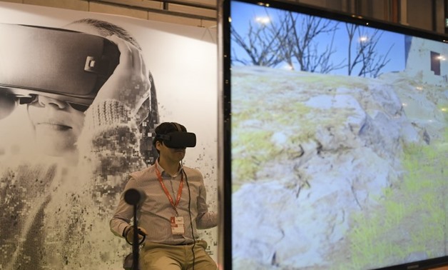 A man uses virtual reality glasses during the International Tourism Fair (FITUR) in Madrid. PHOTO: GABRIEL BOUYS / AFP