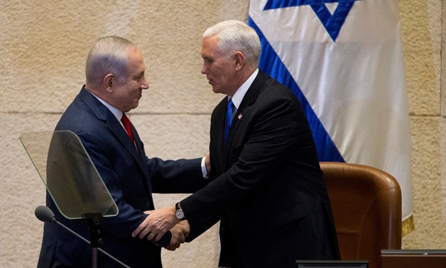 U.S. Vice President Mike Pence shakes hands with Israeli Prime Minister Benjamin Netanyahu ahead of his address to the Knesset, Israeli Parliament, in Jerusalem - Reuters