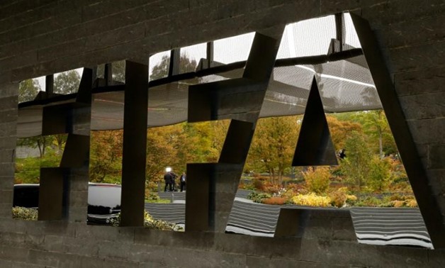 A TV team is reflected in a logo of FIFA a meeting of the FIFA Council at its headquarters in Zurich, Switzerland October 13, 2016. REUTERS/Arnd Wiegmann/Files 