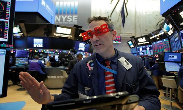Trader Gregory Rowe works on the trading floor as the final day of trading for the year draws to a close with the Dow Jones Industrial Average setting a record high close for a trading year at the New York Stock Exchange (NYSE) in Manhattan, New York, U.S