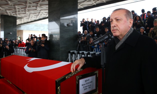 Turkey's President Tayyip Erdogan speaks next to a flag-wrapped coffin of Musa Ozalkan, a Turkish soldier who was killed during the operation against Syria's Afrin region, in Ankara, Turkey January 23, 2018. Kayhan Ozer/Presidential Palace/Handout via REU