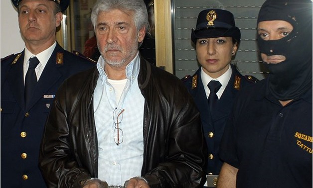Italian state police with Salvatore Lo Piccolo, who magistrates believe is the Sicilian Mafia's new "boss of bosses," after his arrest Monday in Palermo. Credit Italian State Police, via Reuters