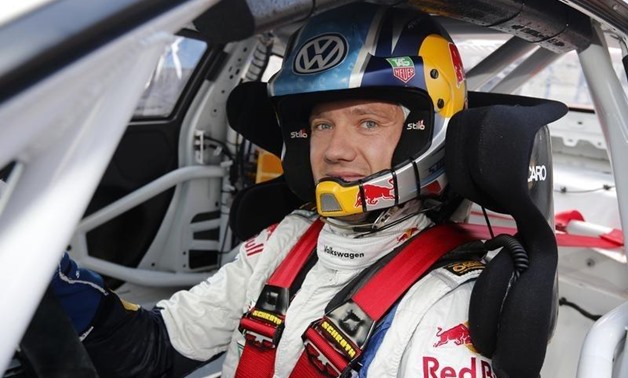 France's driver Sebastien Ogier sits inside his car before the qualifying session of the Porsche Supercup in Monaco, May 24, 2013. REUTERS/Benoit Tessier 