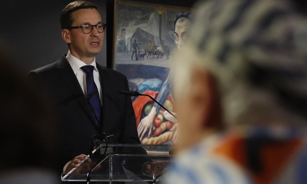 Polish Prime Minister Mateusz Morawiecki speaks at a commemoration event in the so-called "Sauna" building at the former Nazi German concentration and extermination camp Auschwitz II-Birkenau, during the ceremonies marking the 73rd anniversary of the libe