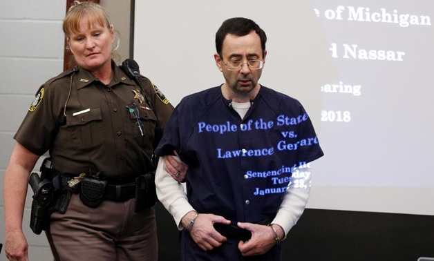 FILE PHOTO: Larry Nassar, a former team USA Gymnastics doctor, who pleaded guilty in November 2017 to sexual assault charges, returns from a break to listen to victim testimony in the courtroom during his sentencing hearing in Lansing, Michigan, U.S., Jan