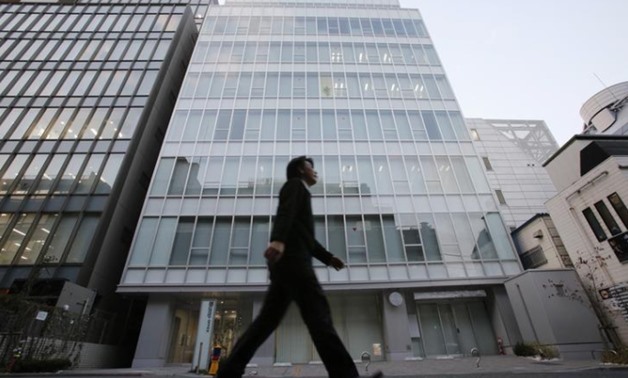 FILE PHOTO: A man walks past a building where Mt. Gox, a digital marketplace operator, is housed in Tokyo February 25, 2014. REUTERS/Toru Hanai