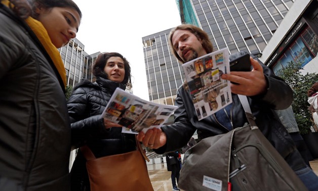 Tour guide Ronnie Chatah, 36, gives the tour brochures to visitors in Beirut January 28, 2018. — Reuters 