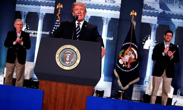 U.S. President Donald Trump, flanked by Senate Majority Leader Mitch McConnell (R-KY) and House Speaker Paul Ryan (R-WI), takes the stage to address the Republican congressional retreat at the Greenbrier resort in White Sulphur Springs, West Virginia, U.S