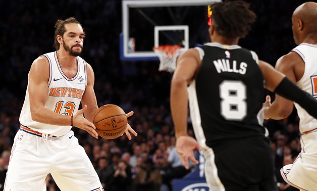 Jan 2, 2018; New York, NY, USA; New York Knicks center Joakim Noah (13) passes the ball in front of San Antonio Spurs guard Patty Mills (8) during the first half at Madison Square Garden. Mandatory Credit: Adam Hunger-USA TODAY Sports
