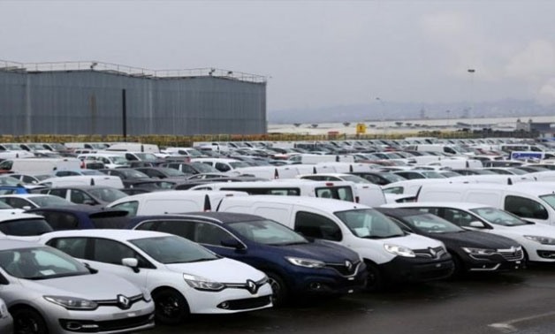Cars and vans parked outside an automobile plant - Reuters 