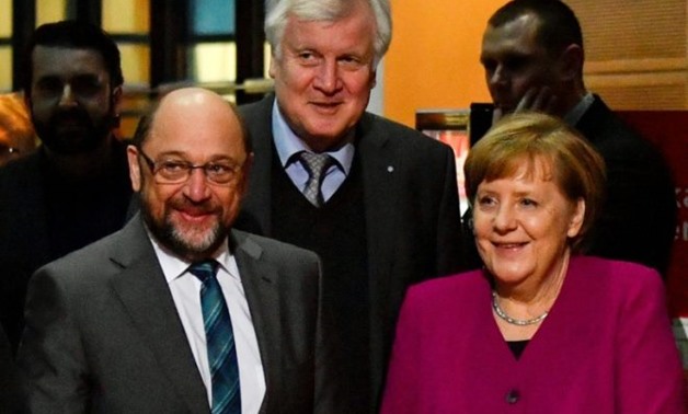 German Chancellor Angela Merkel and Social Democratic Party leader Martin Schulz cannot afford to dig in their heels with many people questioning why it is taking so long to form a coalition - AFP 
