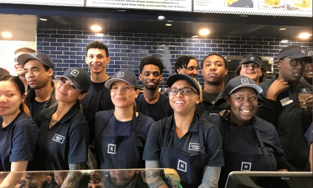 Newly hired employees take a break from training to pose for a group photo at the chain’s soon-to-open 54th outlet in Oakland, California ,U.S., January 24, 2018. REUTERS/Ann Saphir