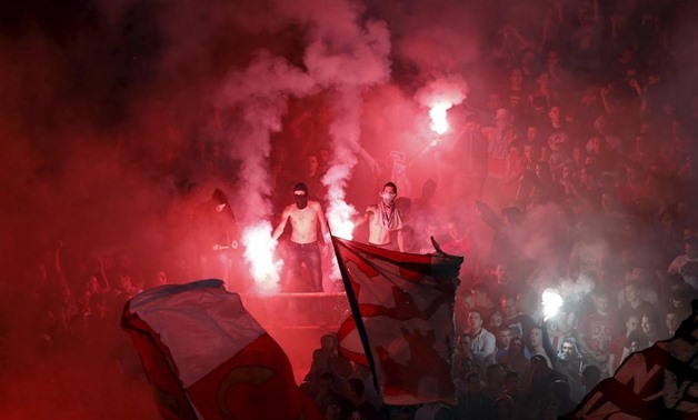 Red Star Belgrade fans cheer and light flares during their Serbian Superliga soccer match against Partizan Belgrade in Belgrade, April 25, 2015.REUTERS/Marko Djurica
