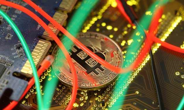 Representation of the Bitcoin virtual currency standing on the PC motherboard is seen - Reuters
