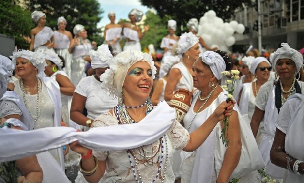 Revellers perform during a "bloco" or informal street party in the run up to Rio's carnival -- but organizers are struggling to pay the bills for the events