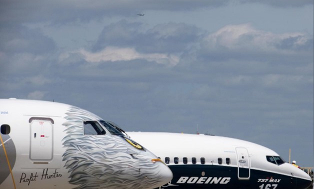 FILE PHOTO: A Boeing 737 MAX and an Embraer E190-E2 are seen on the static display, before the opening of the 52nd Paris Air Show at Le Bourget airport near Paris, France, June 16, 2017. REUTERS/Pascal Rossignol/File Photo