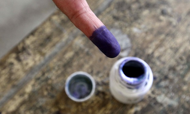 An Egyptian man shows his ink-stained finger after voting in the country’s first free presidential election at a polling station in Cairo. (Khaled Desouki/AFP)