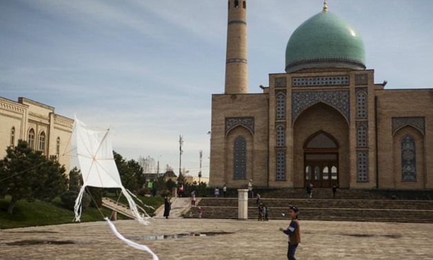 Uzbekistan Tashkent mosque Photo: A boy plays with a kite at Khast Imam square in Tashkent March 21, 2015. REUTERS/Stringer