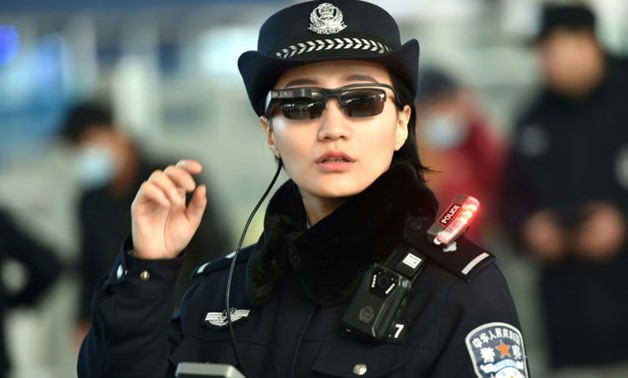 A Chinese police officer wears a pair of smartglasses with a facial recognition system at Zhengzhou East Railway Station in Zhengzhou in China's central Henan province - Photo AFP
