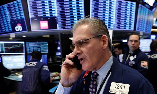 FILE PHOTO: A trader works on the floor of the New York Stock Exchange shortly after the opening bell in New York, U.S., January 5, 2018. REUTERS/Lucas.