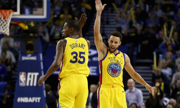 Kevin Durant (L) scored 24 points and Stephen Curry added 20 as the Golden State Warriors snapped out of the doldrums with a 121-103 victory over the Dallas Mavericks, on February 8, 2018
