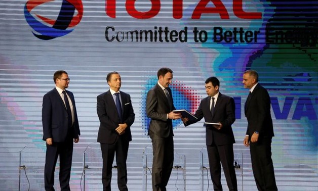 Lebanese Energy Minister Cesar Abi Khalil hands a document to Stephane Michel, Total's head of exploration and production in the Middle East and North Africa, during Lebanon's first offshore oil and gas contract ceremony in Beirut, Lebanon February 9, 201