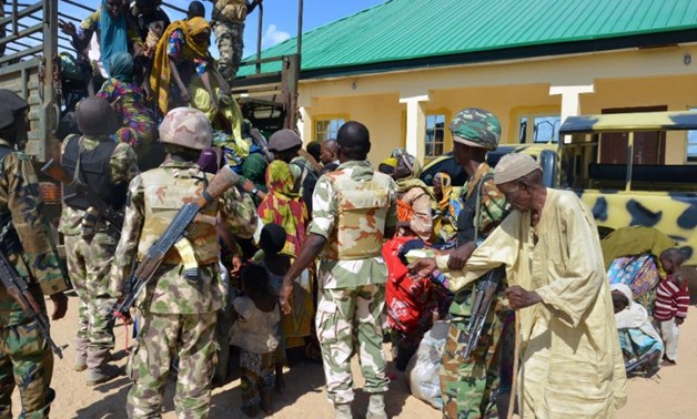 Soldiers assist onto a truck some of the 59 individuals rescued from Boko Haram camps - Reuters
