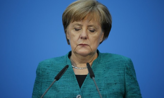 Christian Democratic Union (CDU) leader and German Chancellor Angela Merkel gives a statement together with Christian Social Union (CSU) leader Horst Seehofer and Social Democratic Party (SPD) leader Martin Schulz after coalition talks to form a new coali