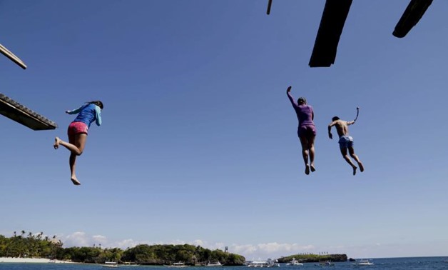 Tourists jump from a 20-feet cliff at one of the islets off the island of Boracay, central Philippines January 18, 2016.
REUTERS/CHARLIE SACEDA