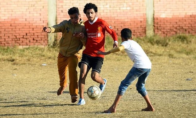 Boys play football at the Mohamed Salah Youth Center in the Egyptian village of Nagrig, the home village of Liverpool's top scorer and Africa's top player Mohamed Salah - AFP