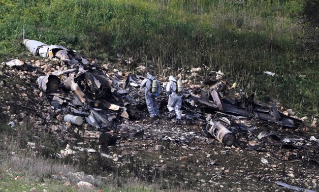 Israeli security forces examine the remains of an F-16 Israeli war plane near the Israeli village of Harduf, Israel February 10, 2018. REUTERS/Ronen Zvulun