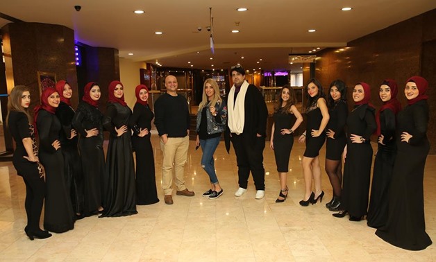 Co-founder of the Queen of Elegance Competition Mohamed Nagh and women participants - Press Photo